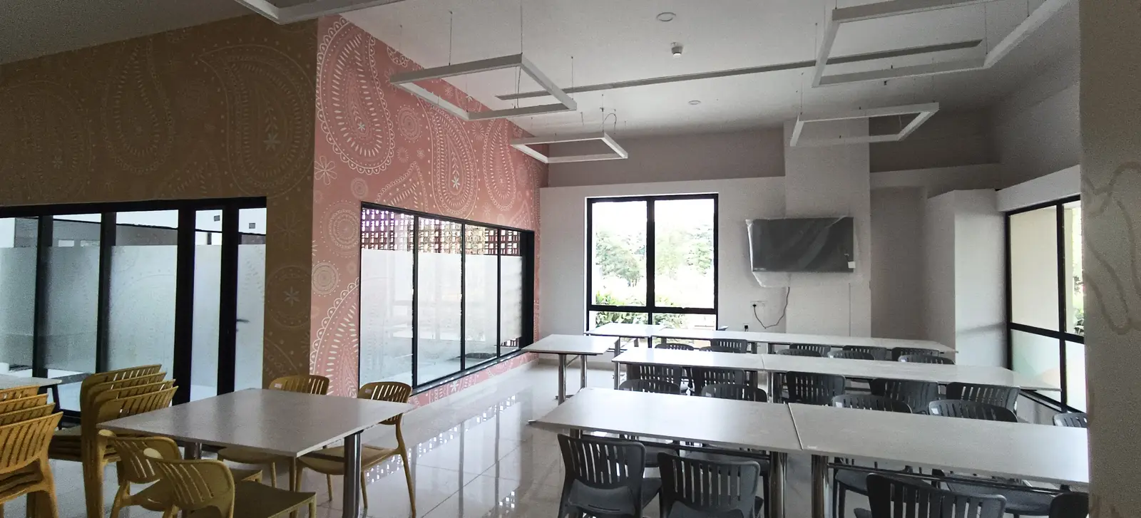 Building Finishes — Office cafeteria with long dining tables