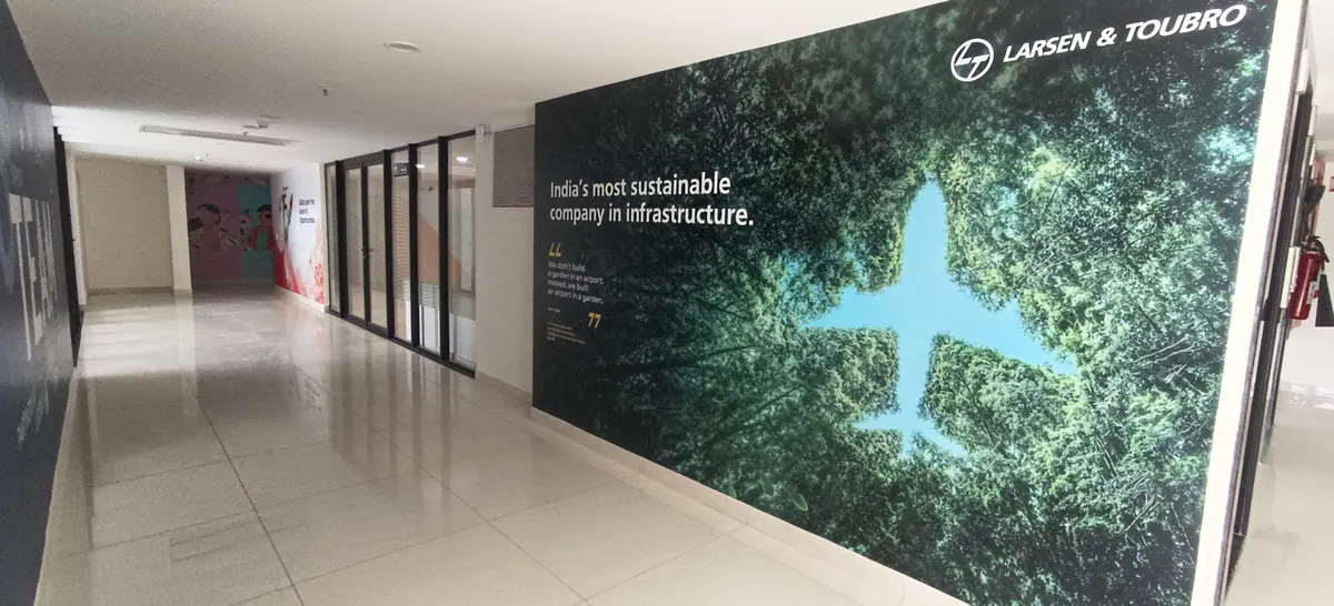Building Finishes — Long office corridor with a large feature wall