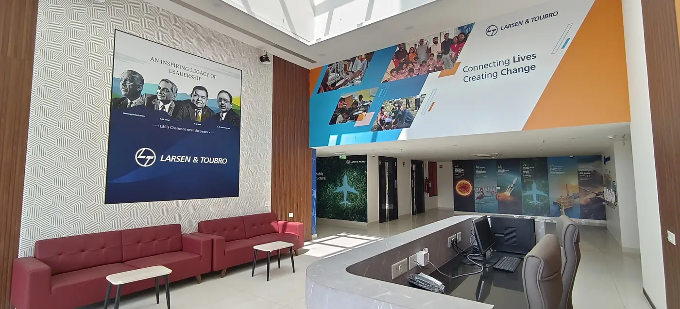 Building Finishes — Office reception lobby with sofas and printed wall graphics