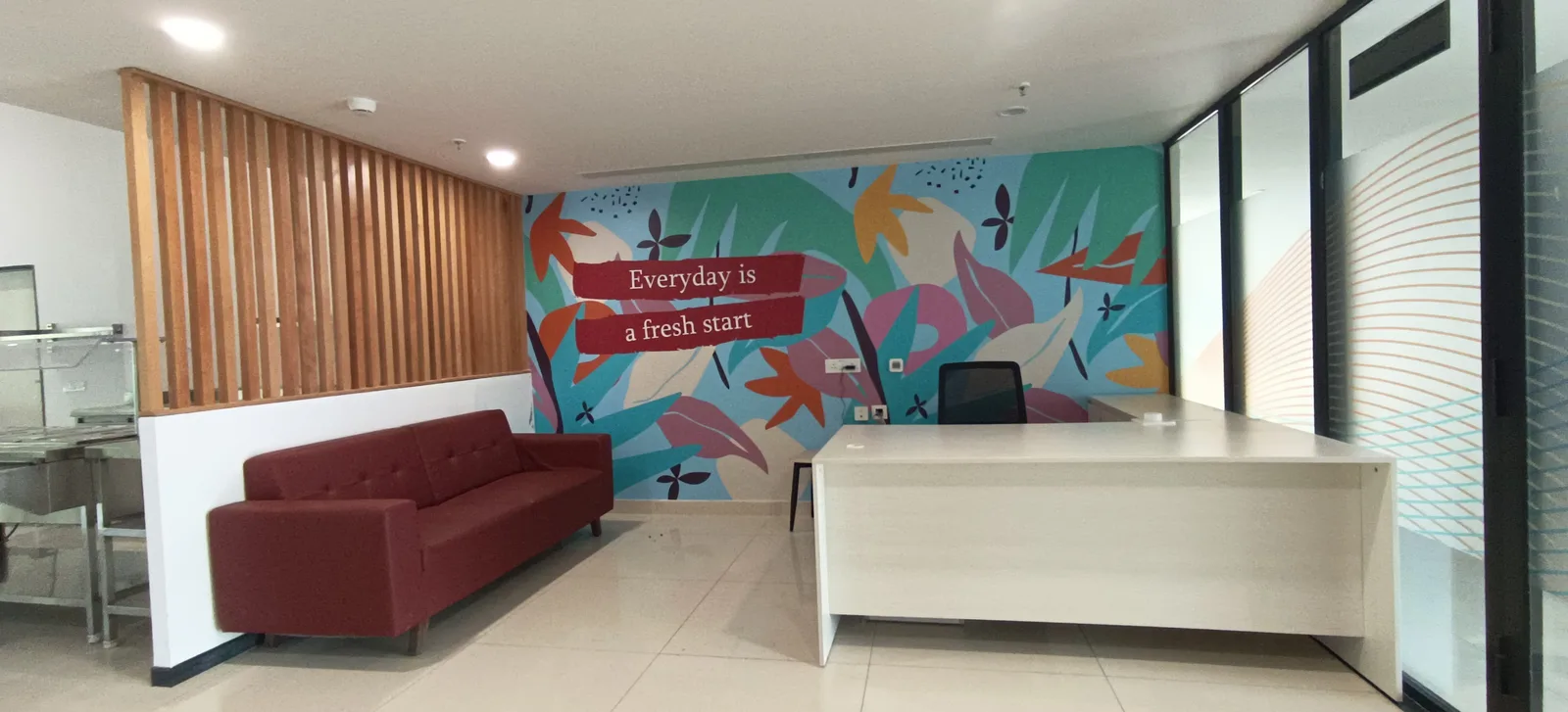 Building Finishes — Reception desk with wooden slat wall and mural