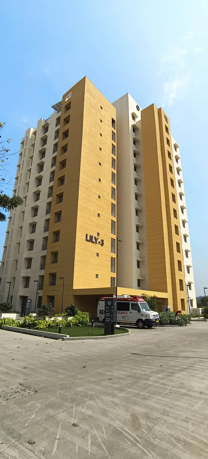 Building Finishes — Residential tower exterior with paved entrance drive