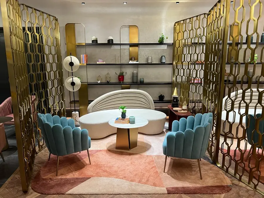 Clubhouses — Lounge with brass hexagon screens and accent chairs