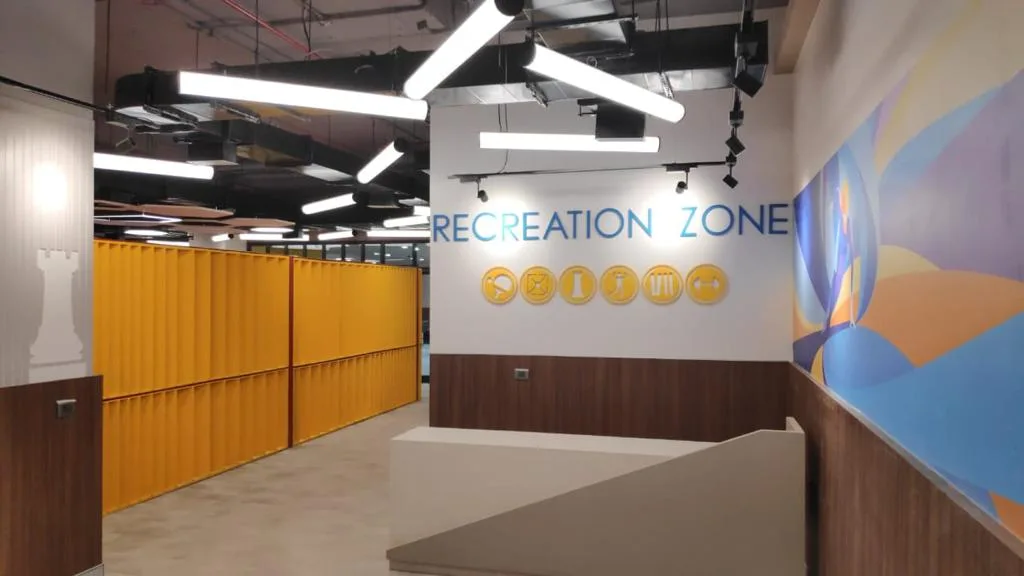 Exposed ceiling services, ductwork and suspended lighting in a recreation area