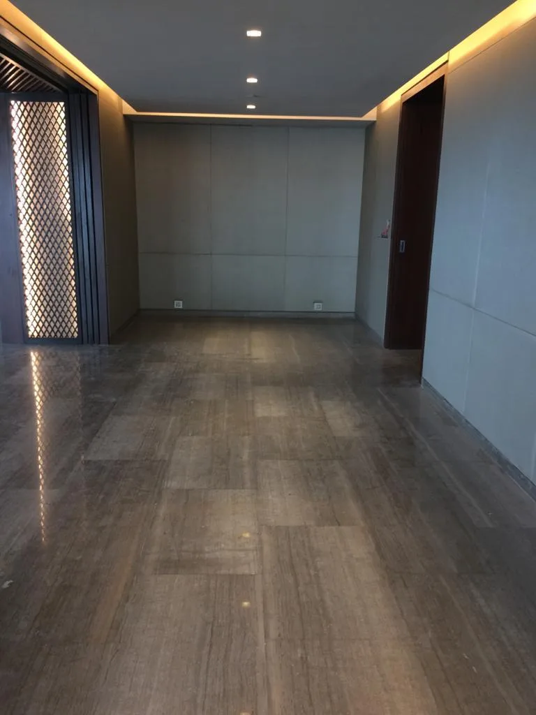 Commercial Interiors — Living room with backlit jaali panel and marble floor