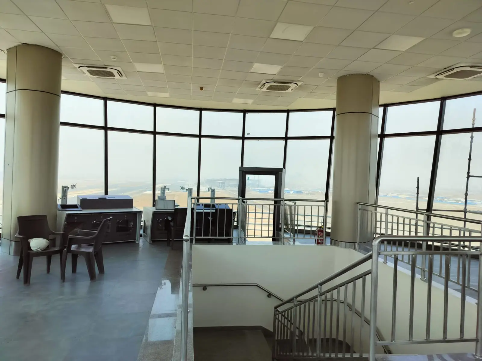 Commercial Interiors — Office lounge with panoramic windows and staircase