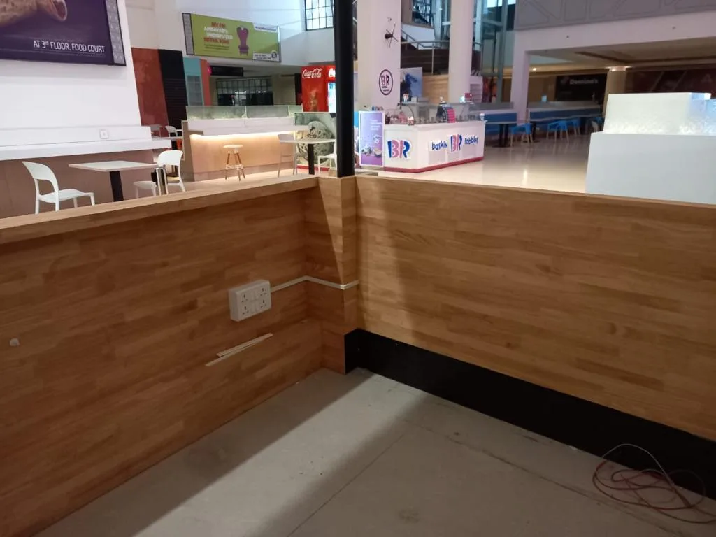 Commercial Interiors — Retail counter with timber cladding in a mall