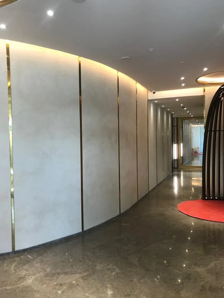 Lobby with marble flooring and a curved finished wall