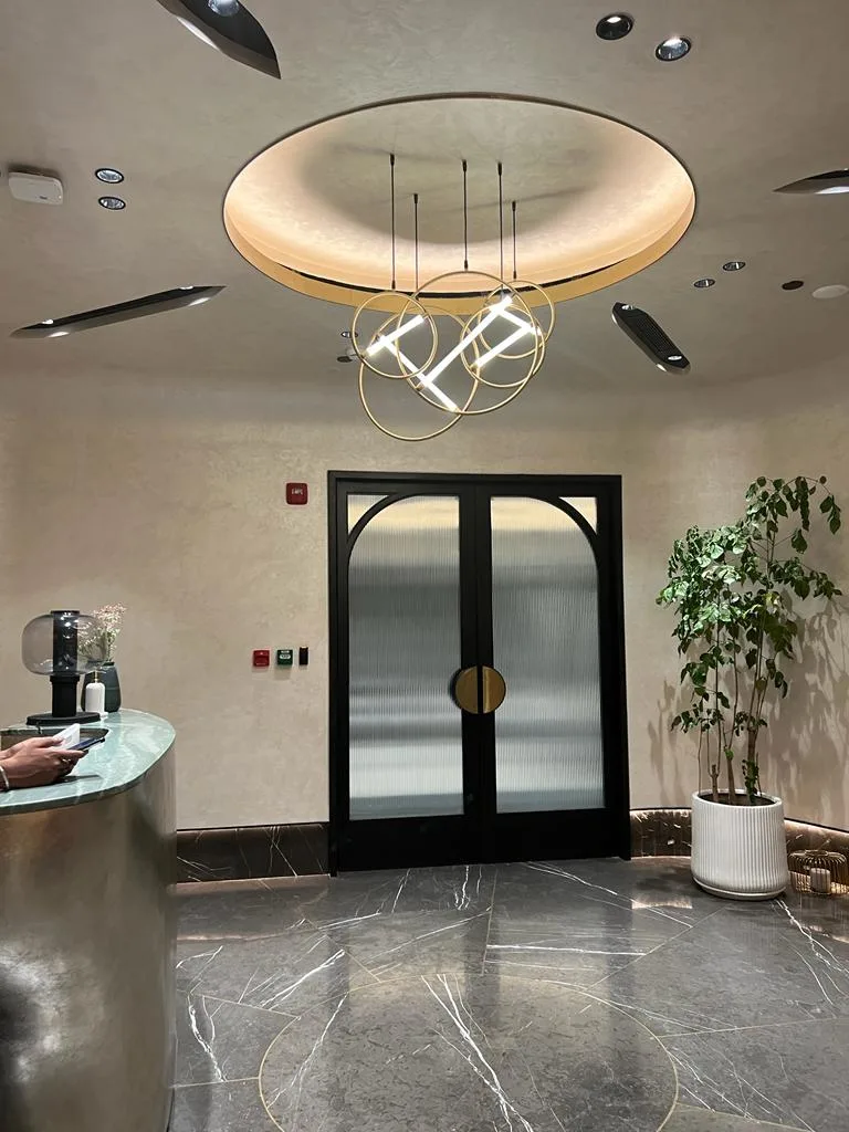Entrance Lobbies — Reception lobby with ring pendant light and arched doors