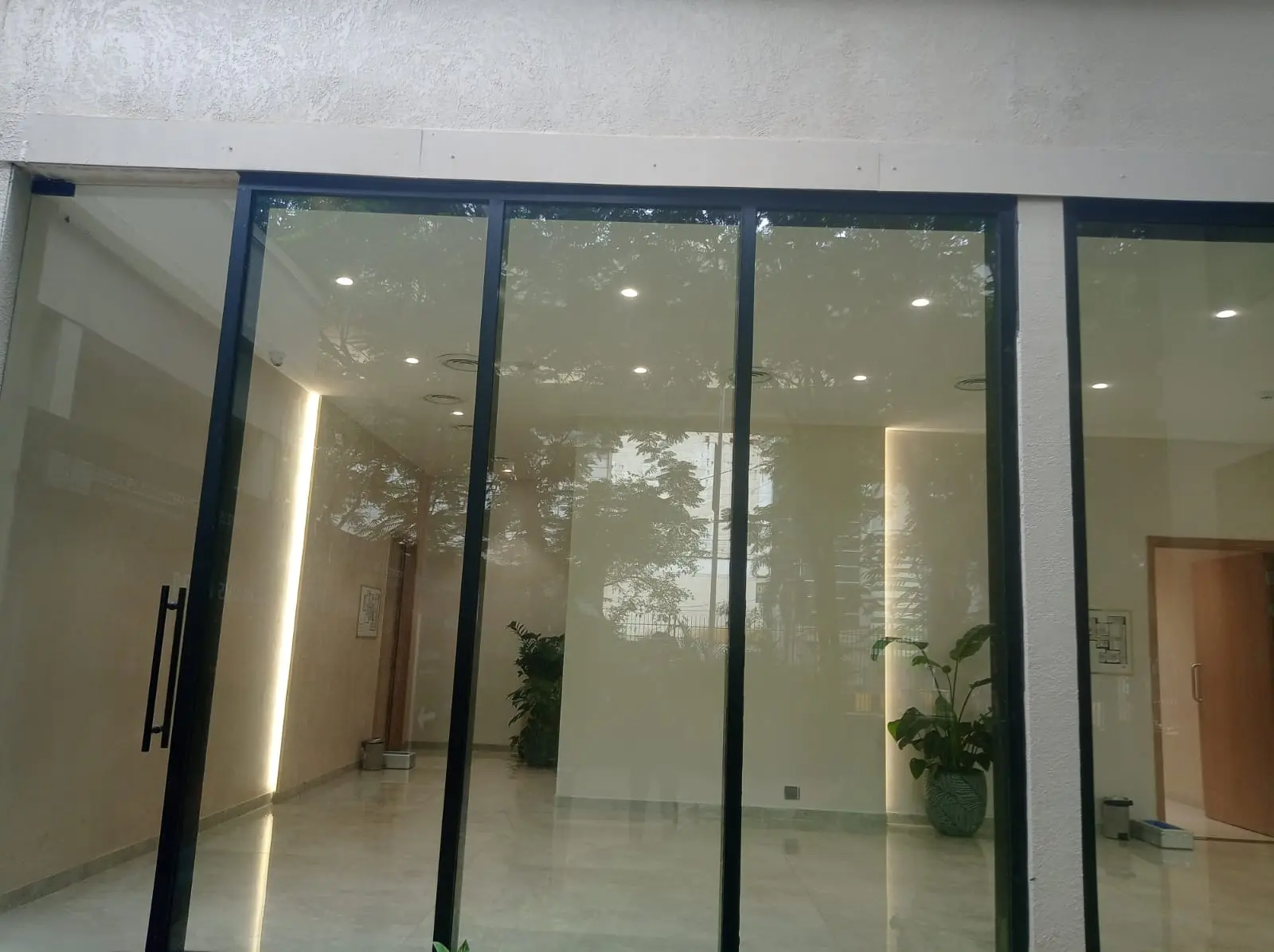 Glazed entrance with dark perimeter framing