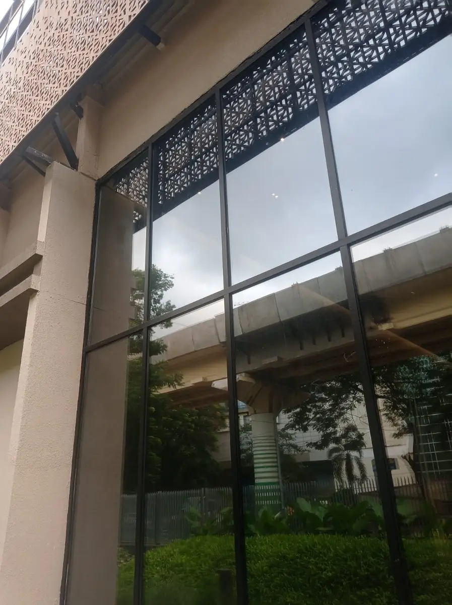 Perforated architectural screens above a glazed facade