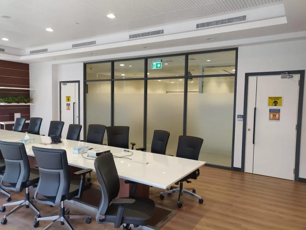 Conference room enclosed by glass partitions