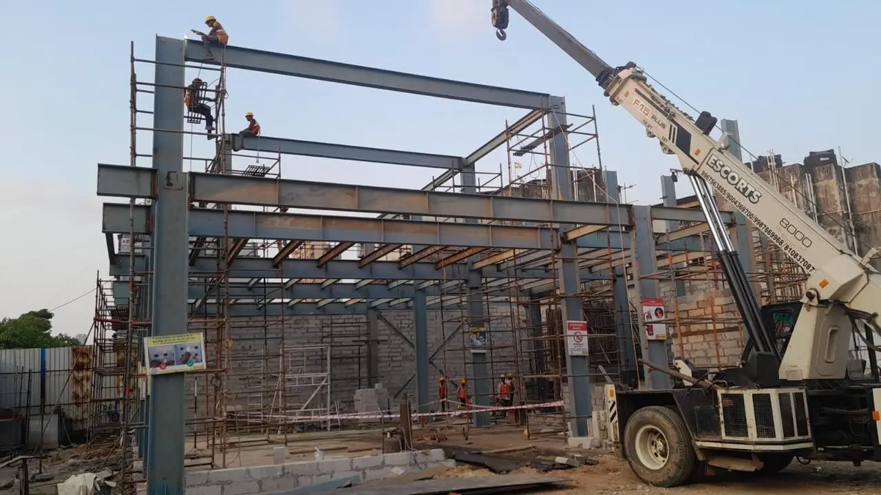 MS Fabrication — Crane lifting steel beams into place