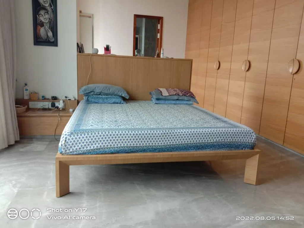 Bedroom with a freestanding bed and fitted timber wardrobes