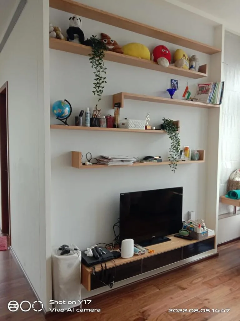Residential Interiors — Living room with floating wall shelves and TV unit