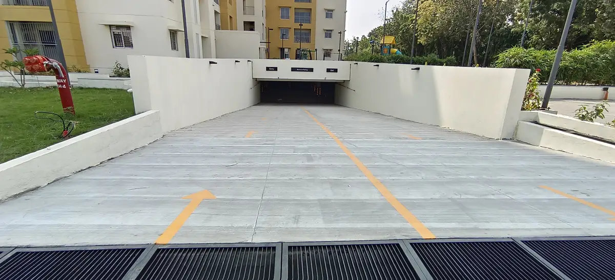 Concrete basement access ramp with drainage grating and lane markings