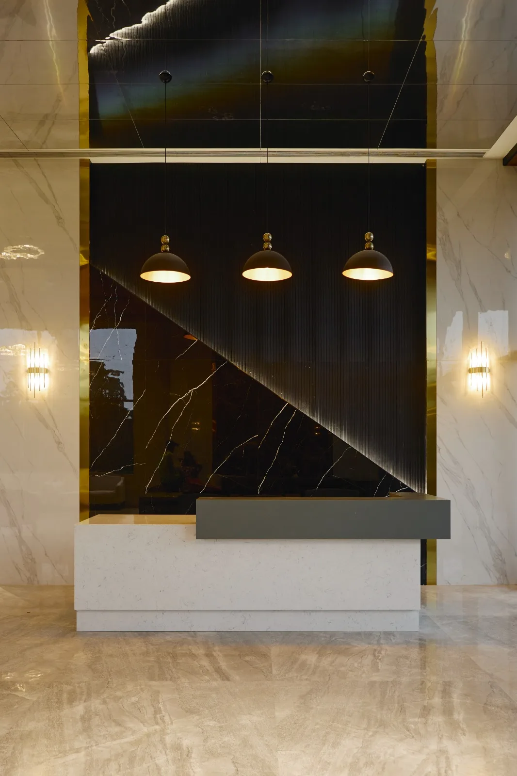 Sales Offices — Reception desk with marble backdrop and pendant lights