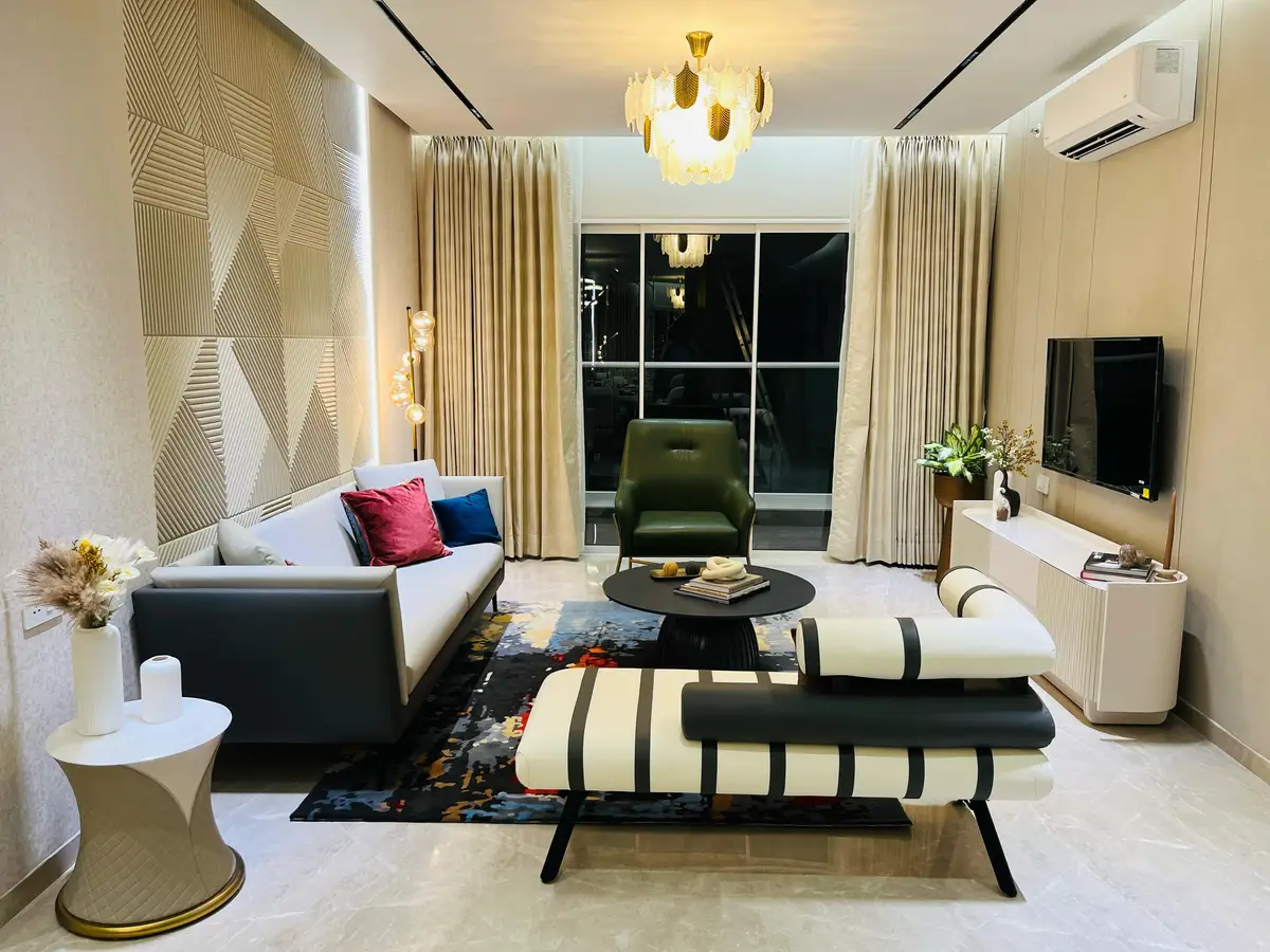 Show Flats — Living room with chandelier and feature wall