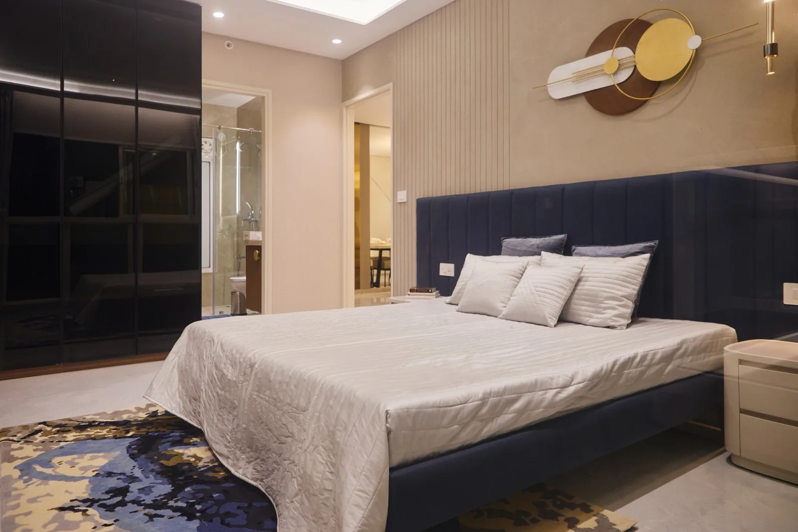 Show Flats — Master bedroom with navy headboard and wall art