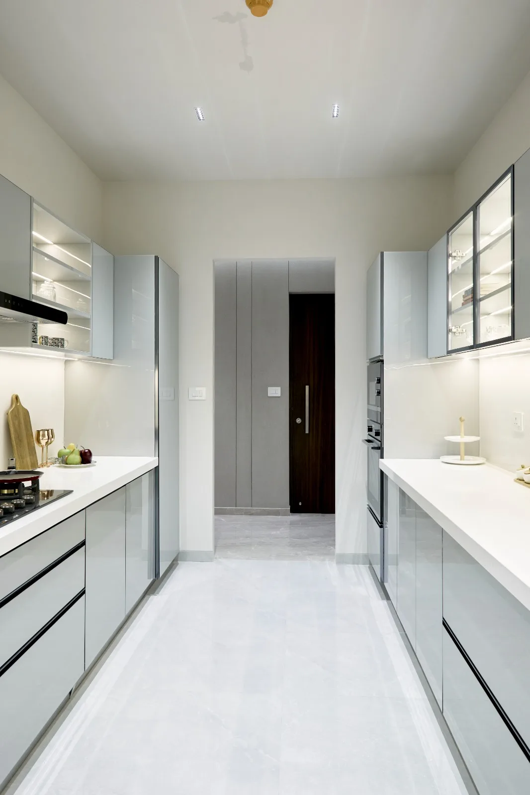 Fitted kitchen cabinetry with grey shutters and a stone worktop