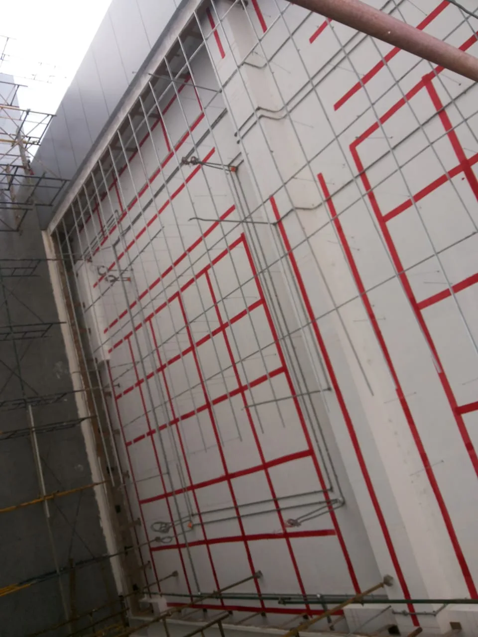 Exterior cladding panels with protective film and access scaffolding