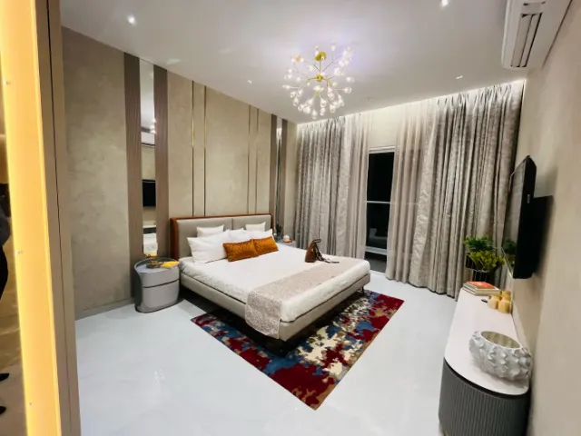 Show Flats — Master bedroom with chandelier and rug